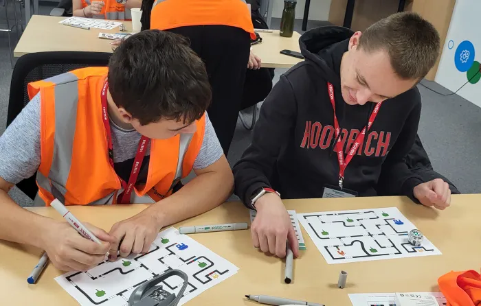 Two students with complex needs from a local school engaging in an Ozobot coding STEM activity at Drayton controls in Plymouth
