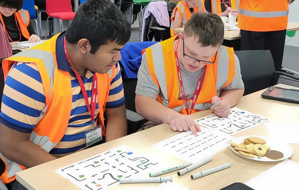 Two students with complex needs engage in an Ozobot coding game at Drayton in Plymouth as part of its STEM outreach program