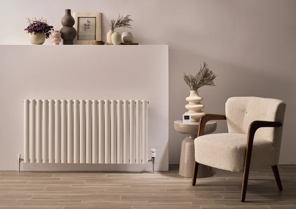 Wiser smart radiator thermostat installed on a radiator valve in a cosy living space